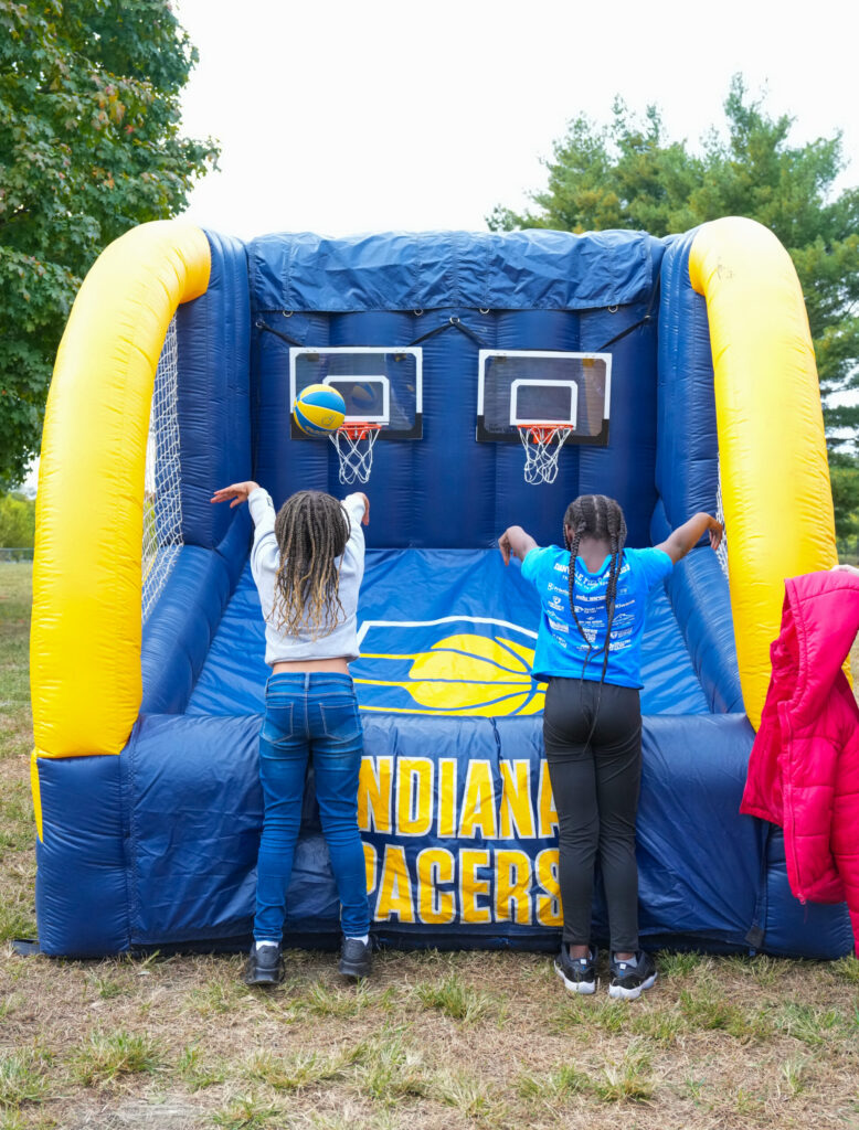 Kids playing on a blow-up basketball net